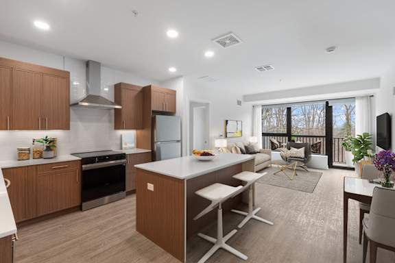 A modern kitchen with wooden cabinets and a large island.