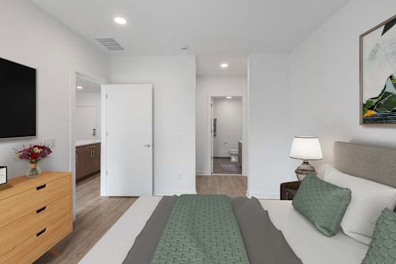A bedroom with a bed, nightstand, and a television.