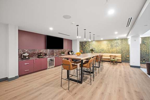 A modern kitchen with a dining table and chairs.