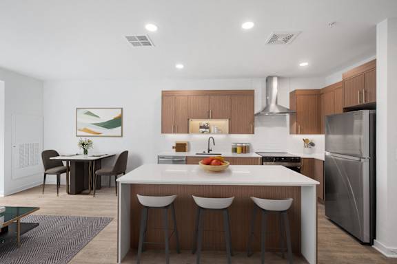 A modern kitchen with a dining table and chairs.