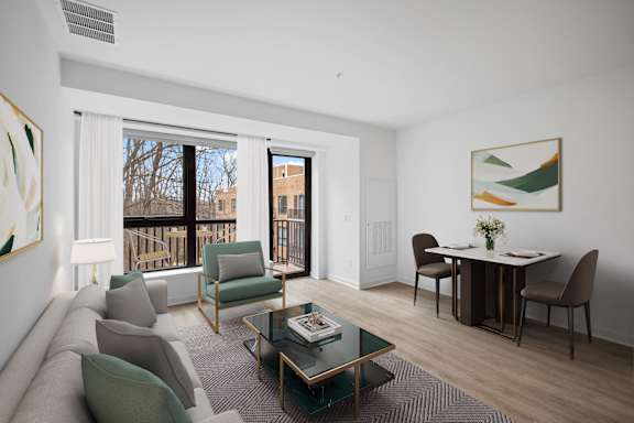 A living room with a couch, chairs, and a dining table.