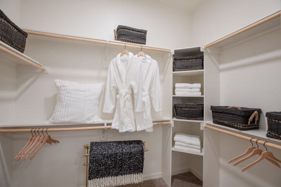 a spacious walk in closet with open shelving