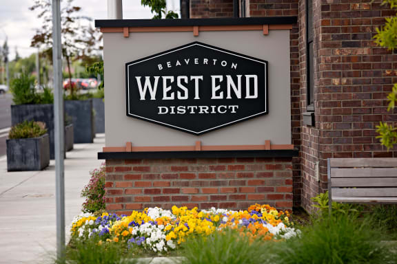 a sign on the side of a building that says west end district