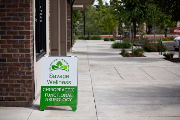 a sign outside a building that says savage wellness chiropractic functional neurology