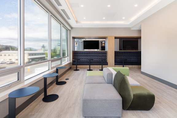 a living room with couches and a television in a hotel room