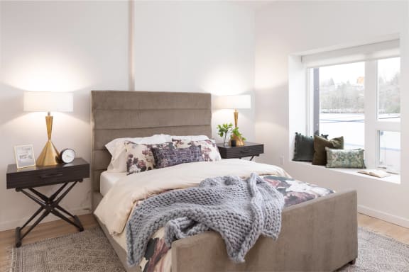a bedroom with a large bed and a window