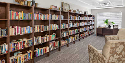 A room filled with bookshelves and a chair.