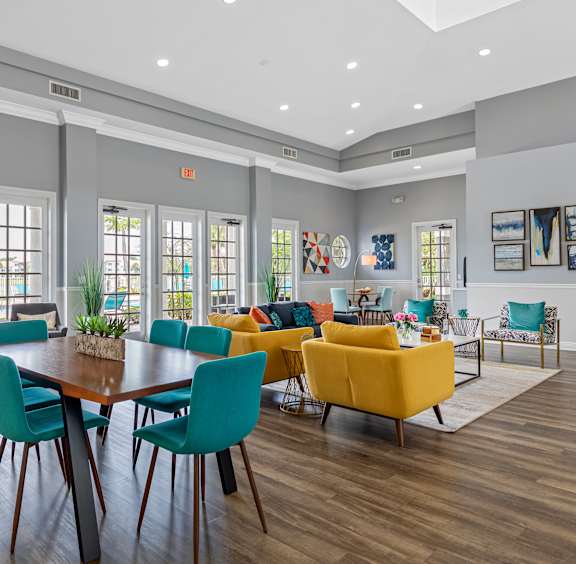 A dining room with a wooden table surrounded by chairs.