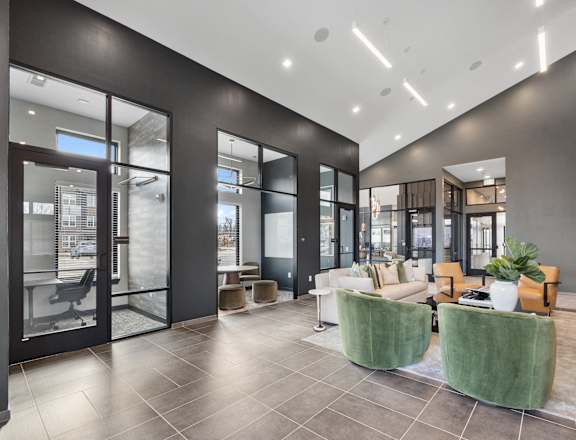Modern clubhouse at Nook Nine with stylish lounge seating, private workspaces, and high ceilings.