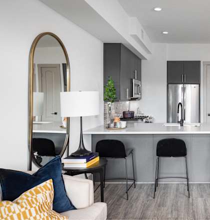 a kitchen and living room with a white counter top and a white