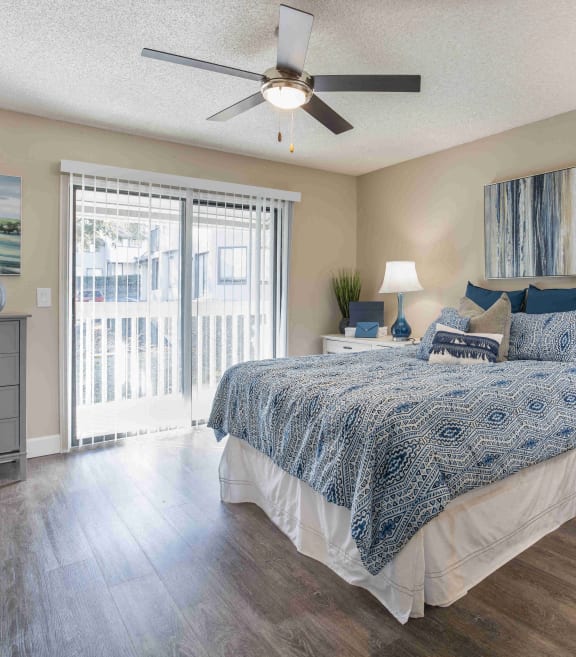 a bedroom with a bed and a ceiling fan