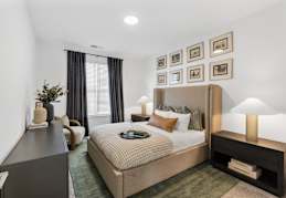 A well-lit bedroom with a large bed and a green carpet. at Portrait Midtown Apartments, Indiana, 46032