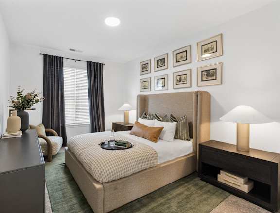Elegant bedroom at Nook Nine with plush bedding, modern decor, and natural light.