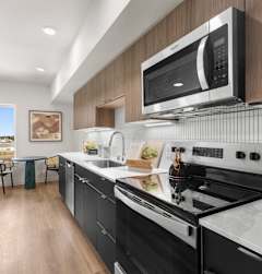A kitchen with wooden cabinets and a table with chairs at Two 10 by Vintage, Shoreline, Washington