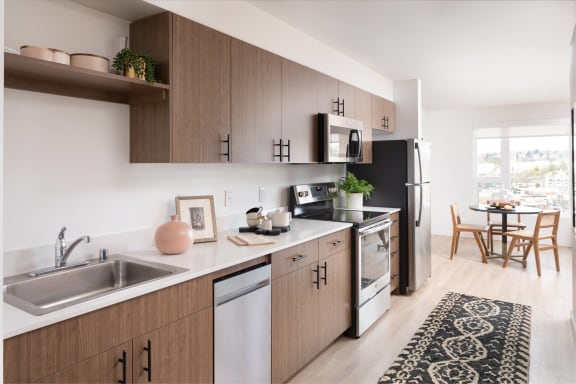 a kitchen with wooden cabinets and a sink and a window