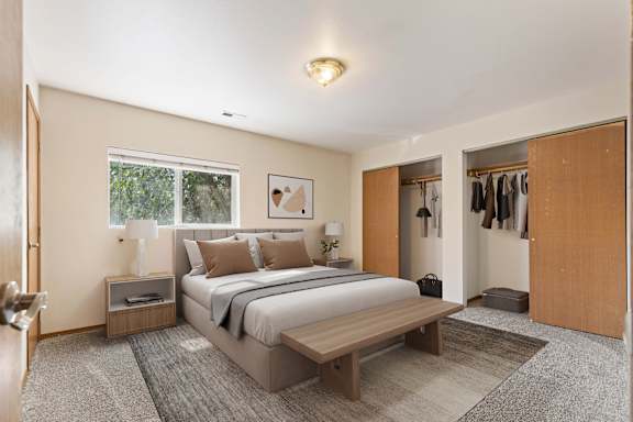 a bedroom with a bed and a bench in a 555 waverly unit
