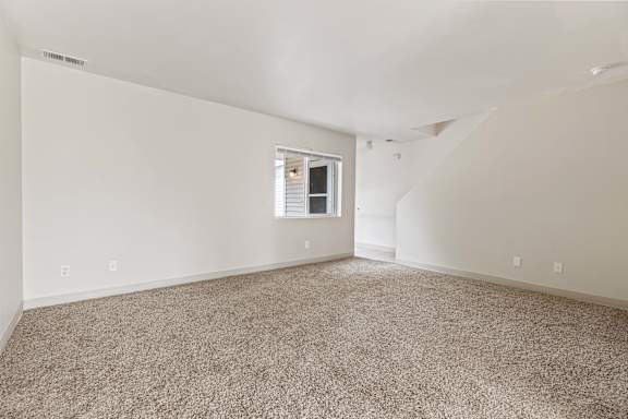 a bedroom with white walls and carpet