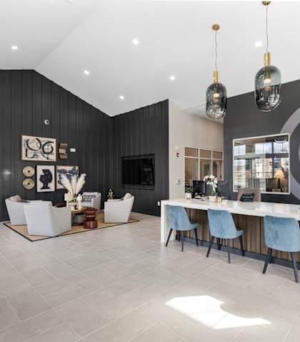 A modern dining room with a long table and chairs.