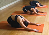 Thumbnail 4 of 8 - Three people doing yoga on orange mats in a row at Ironwood Apartments, Coeur d'Alene, Idaho