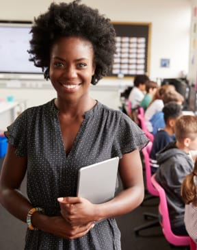 a teacher standing in front of a classroom of students
