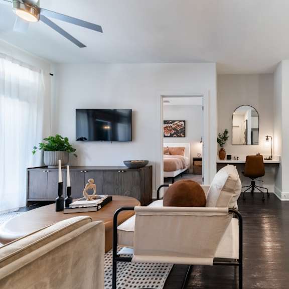 a living room with a couch and a chair and a television