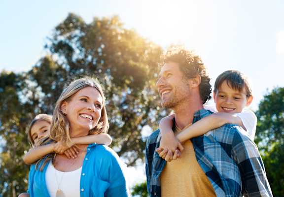 A family of four is enjoying a sunny day outdoors.