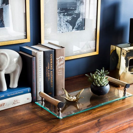 a shelf with books and an elephant statue on it at Avellan Springs Apartments, Morrisville, NC