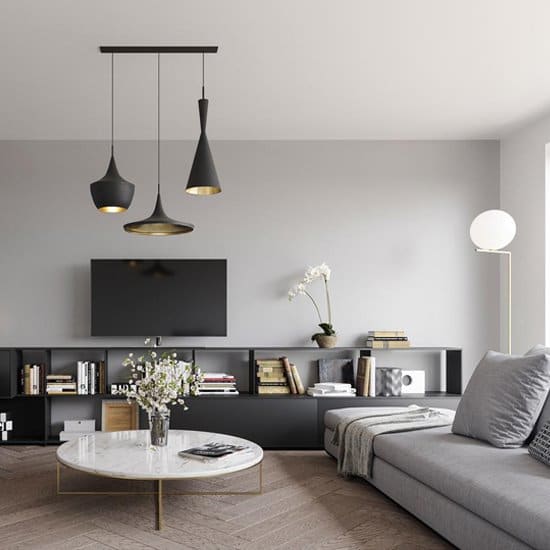 a living room with grey couch and white coffee table