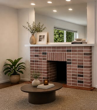 A living room with a fireplace and a dining table.