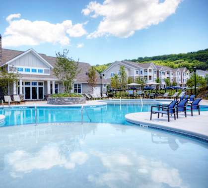 a large swimming pool with a house in the background  at Lullwater at Big Ridge, Hixson, TN, 37343