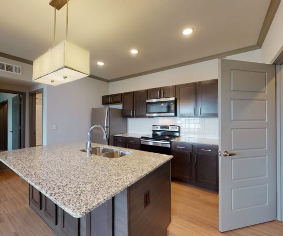 a kitchen with a granite counter top and a sink