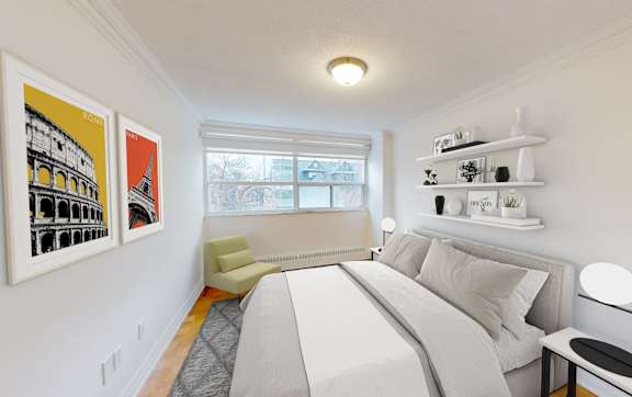 A bedroom with a large bed and a window.