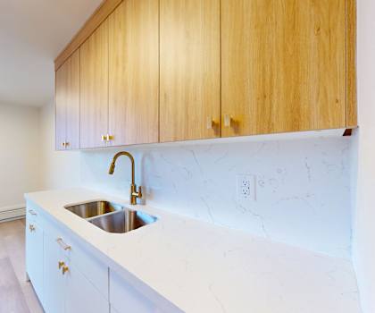 A kitchen with wooden cabinets and a white countertop.
