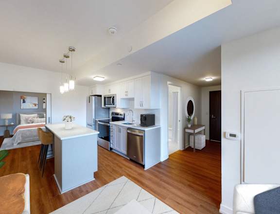 A modern kitchen with a dining table and chairs.