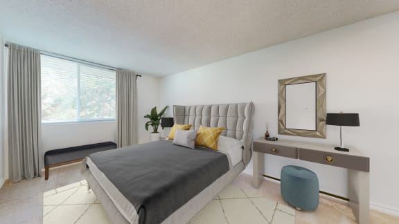 a bedroom with a bed and a desk with a mirror  at Sunset Barrington Gardens, Los Angeles