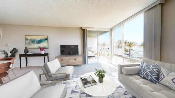 A living room with a white couch and a painting on the wall. at Marina Harbor, Marina del Rey, CA