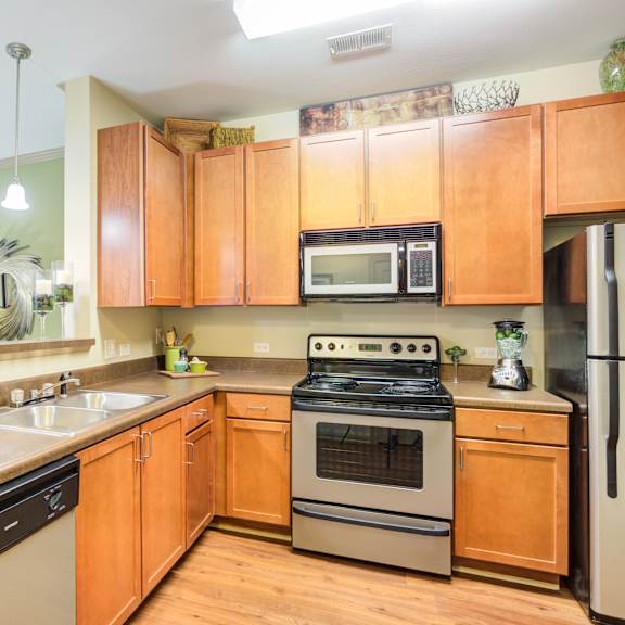 A kitchen with wooden cabinets and a black stove top oven.