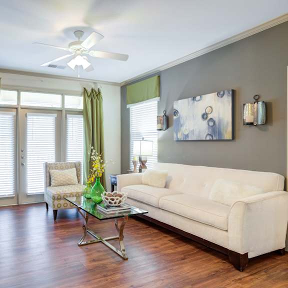 A living room with a white couch and a television.