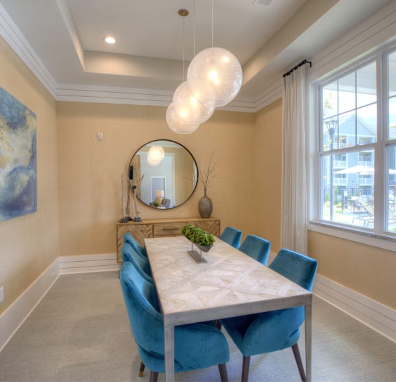 a dining room with a table and chairs and a large window  at Lullwater at Big Ridge, Hixson, TN, 37343