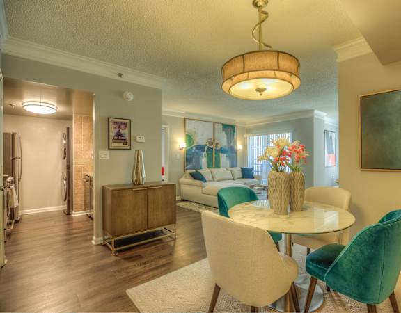 a living room and dining room with a table and chairs