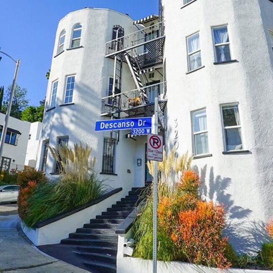 a white building with a street sign in front of it