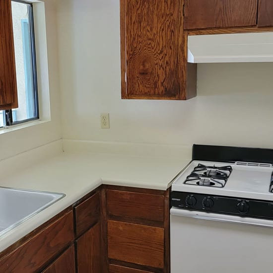 a kitchen with a stove sink and a window