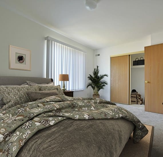 a bedroom with a bed and a ceiling fan  at Charter Oaks Apartments, Michigan, 48423