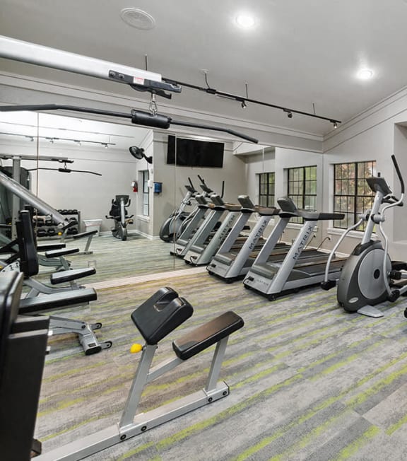 a gym filled with cardio equipment and weights at Heatherstone, Texas, 75287