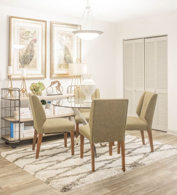a dining room with a table and chairs
