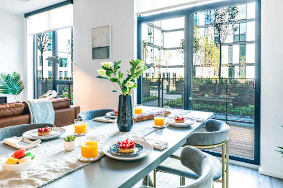 a dining room table with plates of food and a vase of flowers