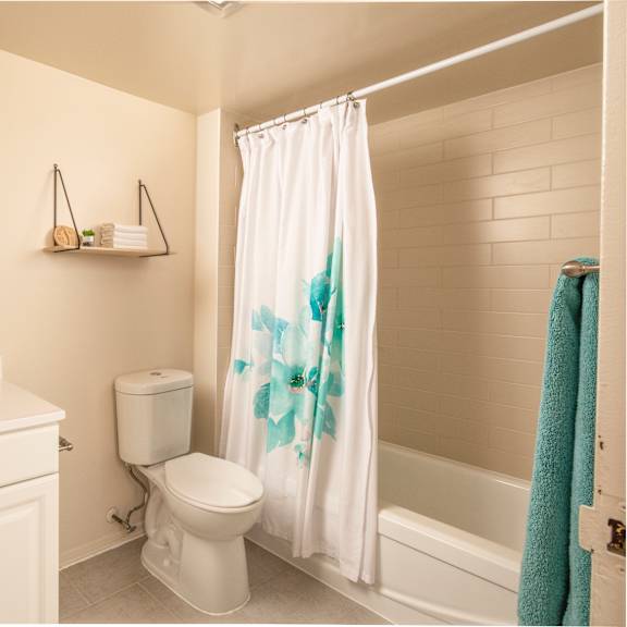 A white bathroom with a white toilet and sink.