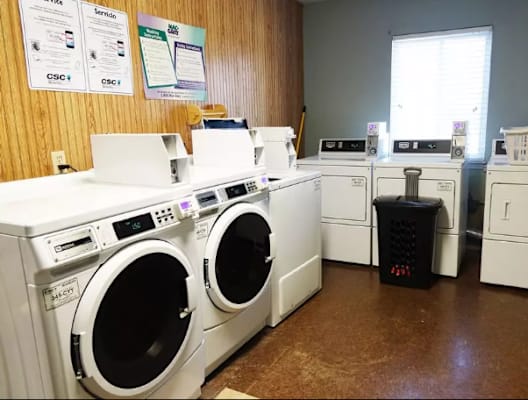 a row of washing machines in a laundromat