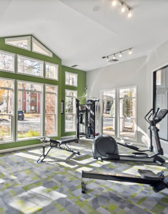 workout room with gym equipment and windows