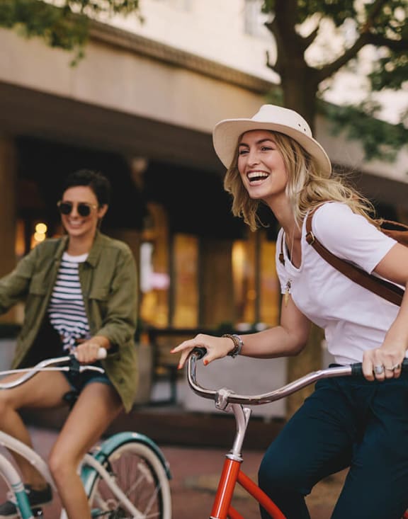 Stock Photo of Two Women Riding Bikes-MEDAM.